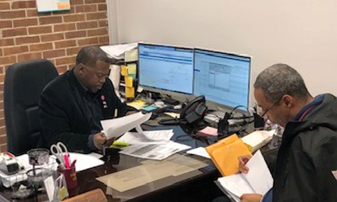 Reginald Sims, an accredited VFW service officer in Jackson, Tenn., helps a veteran apply for benefits. Sims is a life member of VFW Post 6496 in Jackson.