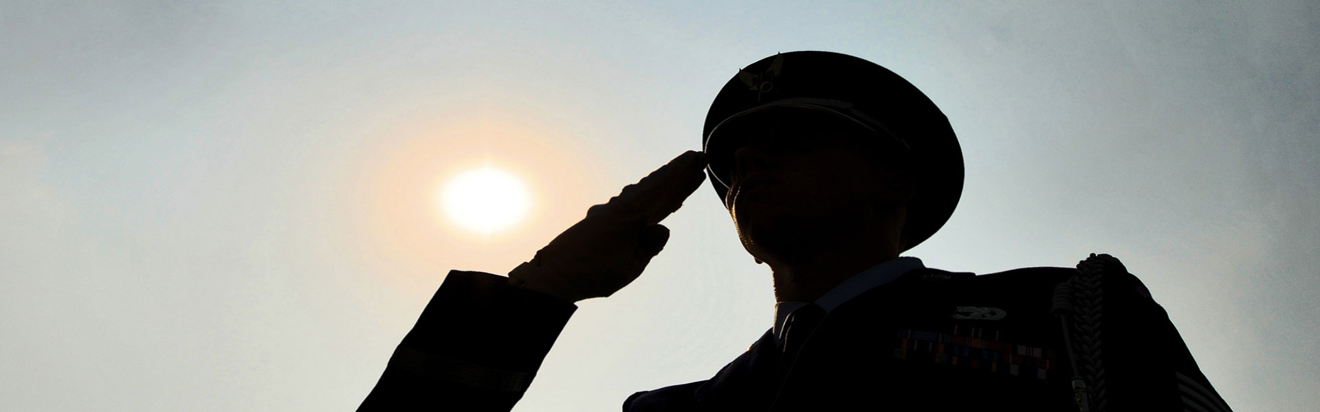 Silhouette of soldier saluting