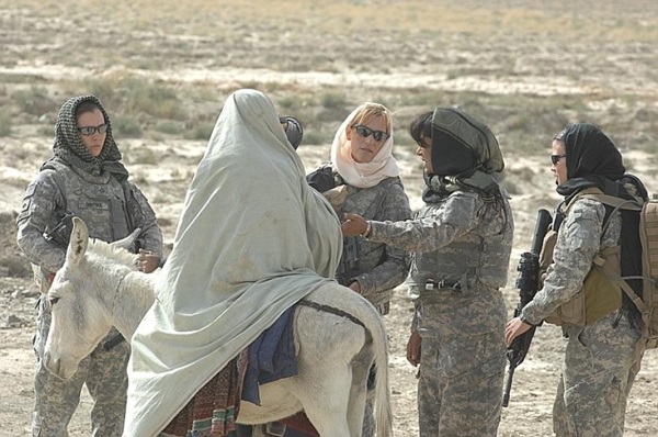 Women service members prepare to search a woman on a donkey in Afghanistan's Zabul province
